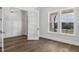 Bright office space with white walls, wainscoting, large windows, and hardwood floors creating a modern aesthetic at 9004 Penny Rd, Raleigh, NC 27606