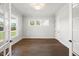 Spacious office with hardwood floors, three windows, and modern lighting at 9004 Penny Rd, Raleigh, NC 27606