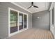 Inviting screened porch has access to the interior of the home and features wood flooring and ceiling fan at 9004 Penny Rd, Raleigh, NC 27606