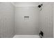 Contemporary shower tiled in white with black fixtures and shower niche at 9004 Penny Rd, Raleigh, NC 27606