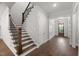 Elegant staircase with wood treads, white risers, and wrought iron railings at 9004 Penny Rd, Raleigh, NC 27606