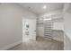 Walk-in closet with an open view to a private bath; shelves line the perimeter for maximum storage at 9004 Penny Rd, Raleigh, NC 27606