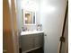 Bathroom vanity featuring gray cabinets and a bright mirror, offering a clean and functional space at 10125 Buffalo Rd, Clayton, NC 27527
