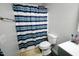 Cozy bathroom with striped shower curtain and classic fixtures in a well-lit space at 10125 Buffalo Rd, Clayton, NC 27527