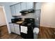 Efficient kitchen layout featuring updated appliances and backsplash at 10125 Buffalo Rd, Clayton, NC 27527