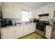 Kitchen features stainless steel appliances and white cabinets at 10166 Buffalo Rd, Clayton, NC 27527