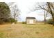 Well-maintained shed with neutral siding, double doors, and windows, providing extra storage in the backyard at 10166 Buffalo Rd, Clayton, NC 27527
