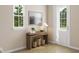 Hallway featuring stylish wooden table with decor and view from window and entrance door at 1032 Zelkova Lane, Chapel Hill, NC 27517