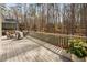 Large wooden back deck overlooking mature trees with ample seating and potted plants at 104 Hampshire Pl, Chapel Hill, NC 27516