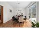 Bright dining room features hardwood floors, a modern chandelier, and a sliding door leading to the deck at 104 Hampshire Pl, Chapel Hill, NC 27516