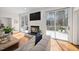 Bright living room features hardwood floors, a sliding glass door, and a fireplace under a flat screen TV at 104 Hampshire Pl, Chapel Hill, NC 27516