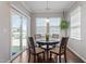 Bright breakfast nook with sliding door, pendant lighting, and cozy seating for four at 11 S Great White Way, Clayton, NC 27527