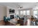 Open-concept living room with a fireplace, kitchen, and an abundance of natural light streaming through the windows at 11 S Great White Way, Clayton, NC 27527