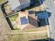 Aerial view of a home with solar panels on the roof and a green lawn at 138 Daneborg Rd, Durham, NC 27703