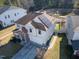 Aerial view of home with solar panels, manicured lawn, and a walkway to a fenced area behind the home at 138 Daneborg Rd, Durham, NC 27703