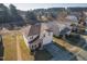 An elevated view reveals a two-story home with stone accents and a view of a pond at 138 Daneborg Rd, Durham, NC 27703