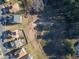 Pond-side homes with solar panels, mature trees, and neighborhood streets at 138 Daneborg Rd, Durham, NC 27703