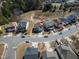 Aerial view of a neighborhood with houses, streets, and a pond at 138 Daneborg Rd, Durham, NC 27703