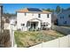 Backyard view of a two-story home with a patio, table, and fenced-in yard at 138 Daneborg Rd, Durham, NC 27703