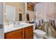 Cozy bathroom featuring a vanity, toilet, and shower with nature-themed curtain at 138 Daneborg Rd, Durham, NC 27703