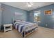 Comfortable bedroom with cozy white metal bed frame, side tables, and a sun-filled window at 138 Daneborg Rd, Durham, NC 27703