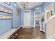 Inviting foyer with blue walls, coat rack, and hardwood-style floors, perfect for welcoming guests at 138 Daneborg Rd, Durham, NC 27703