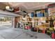Spacious garage with open door, overhead storage, and various tools and equipment at 138 Daneborg Rd, Durham, NC 27703