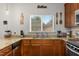 Kitchen with granite countertops, wooden cabinets, stainless steel appliances, and natural lighting at 138 Daneborg Rd, Durham, NC 27703