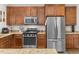 Well-equipped kitchen with stainless steel appliances, wooden cabinetry, and granite countertops at 138 Daneborg Rd, Durham, NC 27703