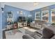 Comfortable living room features a ceiling fan, natural lighting, and neutral-colored sofas at 138 Daneborg Rd, Durham, NC 27703