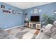 Cozy living room with blue walls, gray sofas, modern furniture, and a decorative rug at 138 Daneborg Rd, Durham, NC 27703