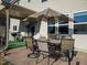 Inviting patio with a table, umbrella, chairs, and grill, perfect for outdoor dining at 138 Daneborg Rd, Durham, NC 27703