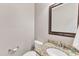 Powder room with granite countertop, oval sink, and decorative mirror at 151 Bennett Pl, Clayton, NC 27527