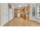 Well-lit kitchen features wooden cabinets, white appliances, and hardwood flooring at 151 Bennett Pl, Clayton, NC 27527