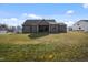 Spacious backyard with lush green grass and a covered patio, ideal for outdoor activities at 203 Mitchell Manor Dr, Angier, NC 27501