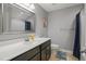 Clean bathroom with a large mirror, single sink vanity, and neutral color scheme at 203 Mitchell Manor Dr, Angier, NC 27501