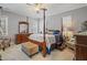 Well-decorated bedroom featuring a four-poster bed, dresser, and natural light at 203 Mitchell Manor Dr, Angier, NC 27501
