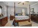 Spacious bedroom features a four-poster bed, neutral walls, and great natural light at 203 Mitchell Manor Dr, Angier, NC 27501