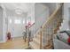 Staircase and entryway featuring hardwood floors, a chandelier, and neutral paint at 203 Mitchell Manor Dr, Angier, NC 27501