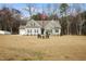 Well-maintained one-story home with a large yard, patriotic flagpole, and welcoming entryway at 203 Mitchell Manor Dr, Angier, NC 27501