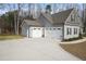 Attached two-car garage with a long, paved driveway and well-maintained exterior at 203 Mitchell Manor Dr, Angier, NC 27501