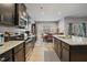 Well-appointed kitchen with dark cabinets, stainless steel appliances, and an open view to the dining area at 203 Mitchell Manor Dr, Angier, NC 27501