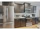 Modern kitchen with stainless steel appliances and dark cabinets, providing a sleek and functional space at 203 Mitchell Manor Dr, Angier, NC 27501