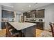 Modern kitchen featuring dark cabinets, granite countertops, and a center island with seating at 203 Mitchell Manor Dr, Angier, NC 27501
