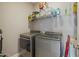 Well-organized laundry room featuring modern washer and dryer units with ample shelving at 203 Mitchell Manor Dr, Angier, NC 27501