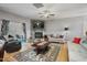 Open-concept living room featuring a stone fireplace, comfortable seating, and sliding glass doors to the outdoor patio at 203 Mitchell Manor Dr, Angier, NC 27501