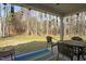 Covered patio with outdoor seating and view of landscaped backyard at 203 Mitchell Manor Dr, Angier, NC 27501