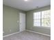 Bedroom with neutral carpet, trim, window, and light green walls at 205 Cedar Elm Rd, Durham, NC 27713