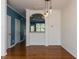 Dining area featuring hardwood floors and unique light fixtures with an arched opening at 205 Cedar Elm Rd, Durham, NC 27713
