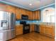 Kitchen with stainless steel appliances, wooden cabinets, and hardwood floors at 205 Cedar Elm Rd, Durham, NC 27713
